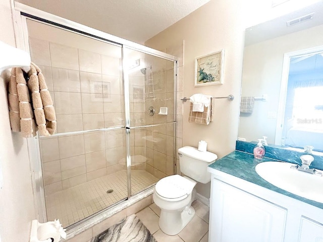 bathroom featuring tile patterned floors, toilet, an enclosed shower, and vanity