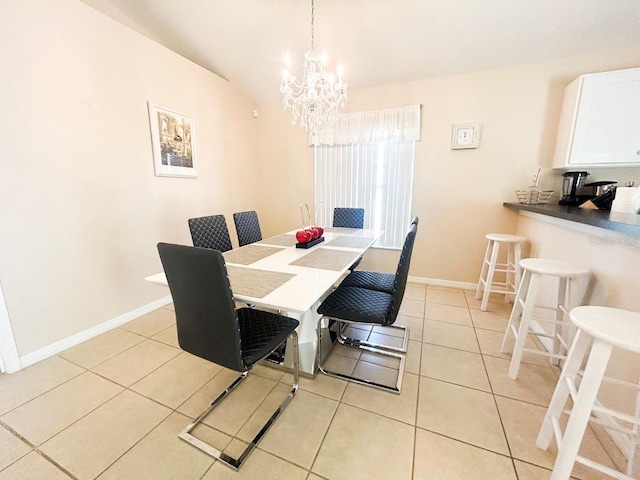 tiled dining area with an inviting chandelier