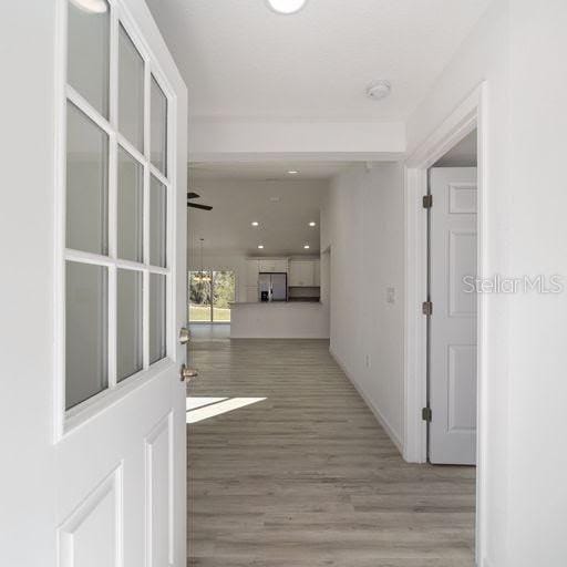 corridor with light wood-type flooring