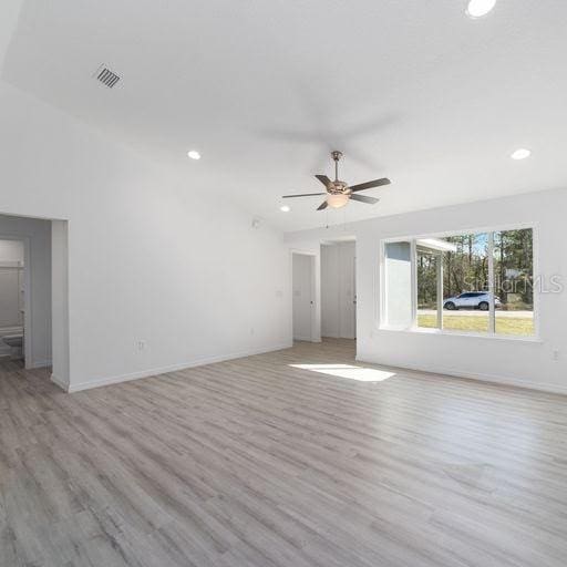 unfurnished living room with light wood-type flooring and ceiling fan