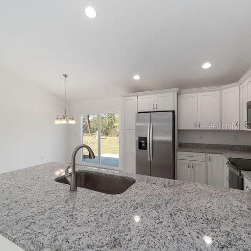 kitchen with sink, white cabinets, and stainless steel appliances