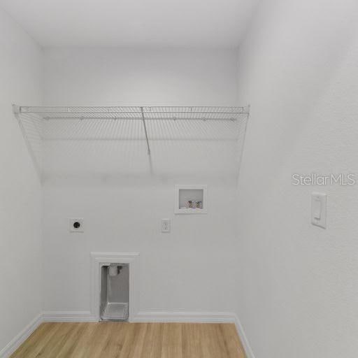 laundry area featuring washer hookup, electric dryer hookup, and hardwood / wood-style flooring