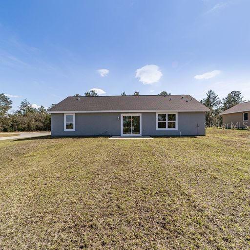 rear view of property with a lawn