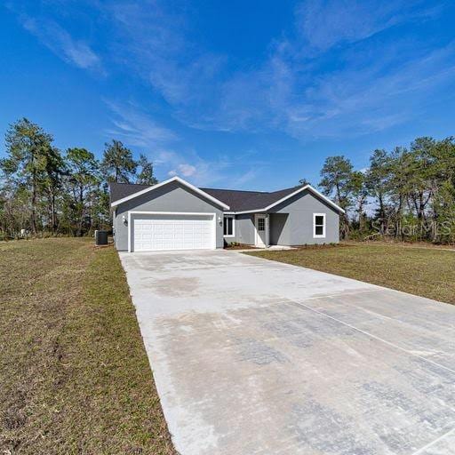 ranch-style home featuring a front lawn and a garage