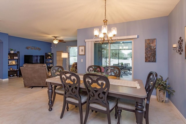 dining area featuring ceiling fan with notable chandelier and light tile patterned floors