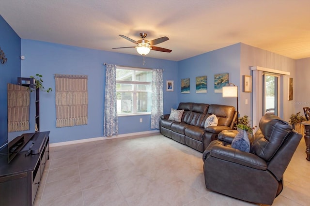 living room featuring ceiling fan and light tile patterned floors