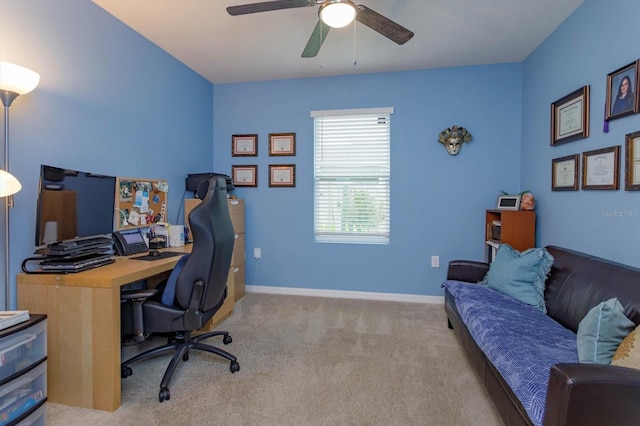 home office featuring ceiling fan and light carpet