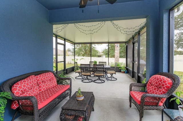 sunroom / solarium featuring ceiling fan