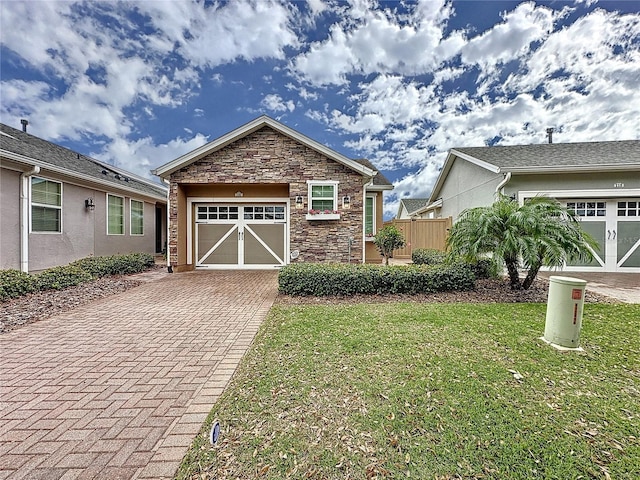 view of front of property featuring a garage and a front lawn