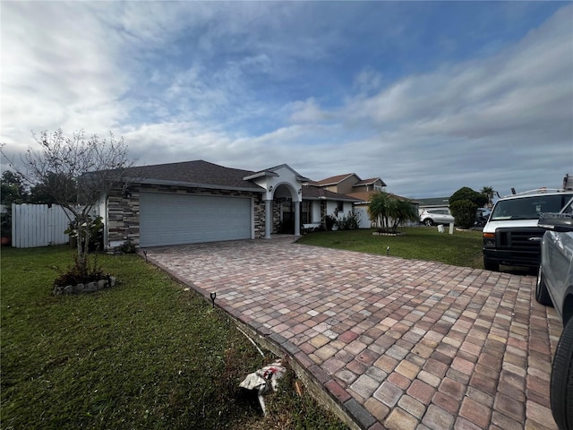 ranch-style home featuring a garage and a front yard