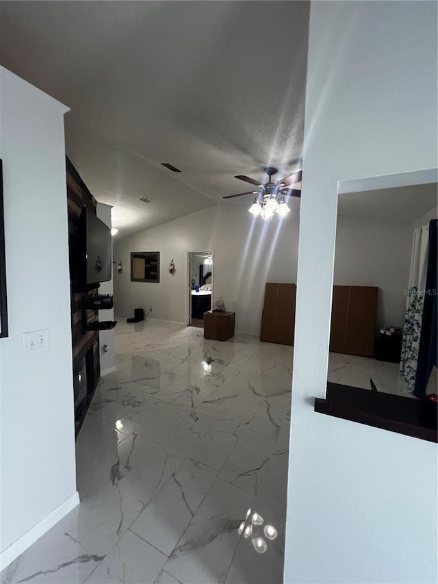 living room featuring ceiling fan and lofted ceiling