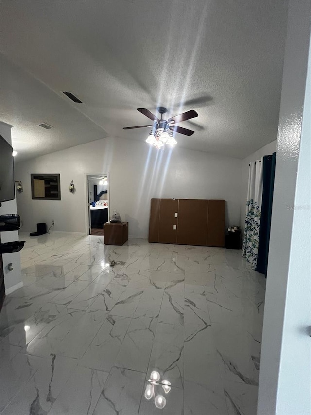 unfurnished living room with a textured ceiling, ceiling fan, and lofted ceiling