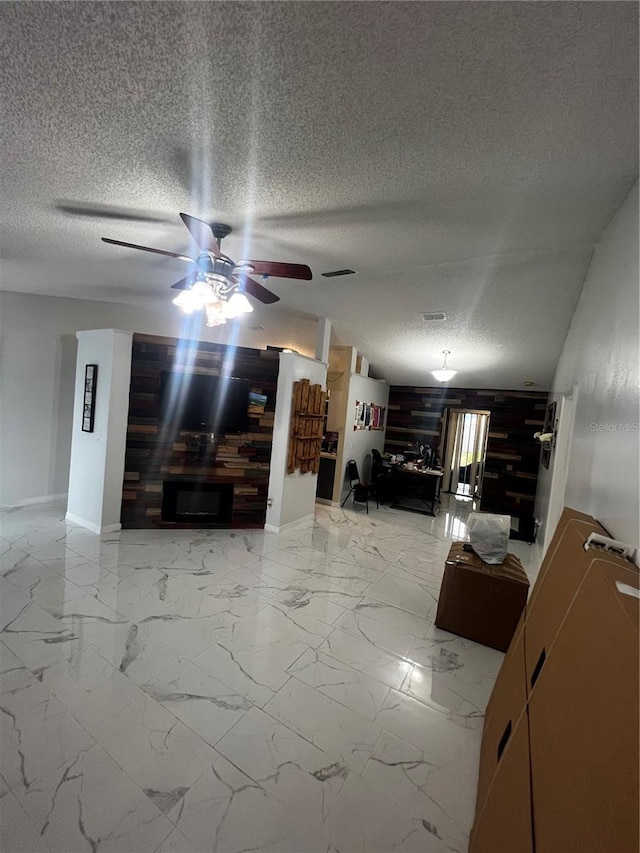 unfurnished living room featuring ceiling fan