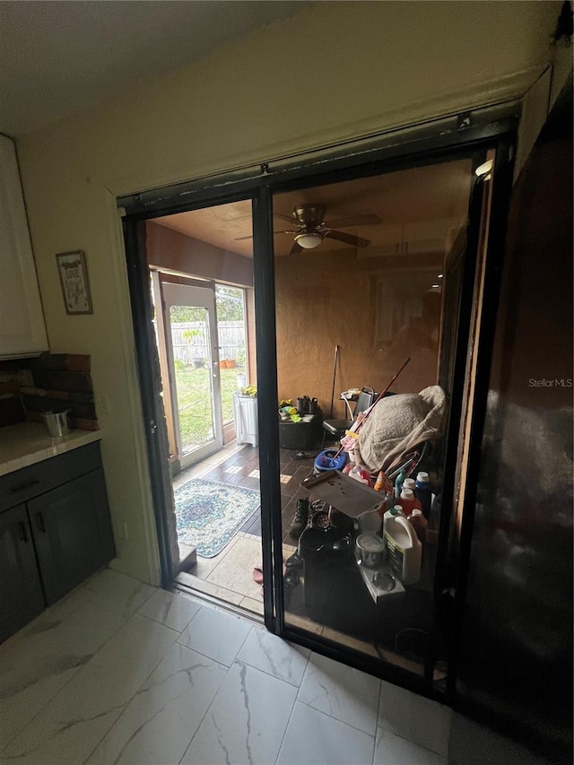 doorway to outside with ceiling fan