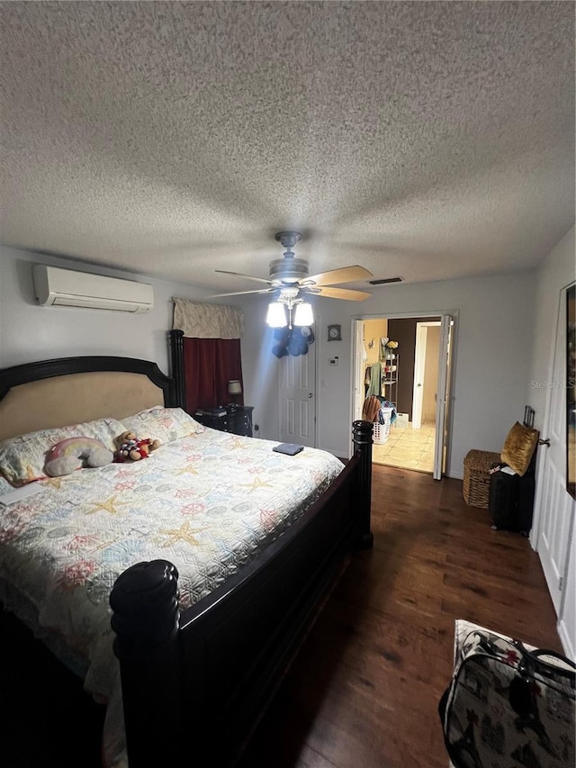 bedroom featuring a textured ceiling, dark hardwood / wood-style flooring, a wall unit AC, and ceiling fan