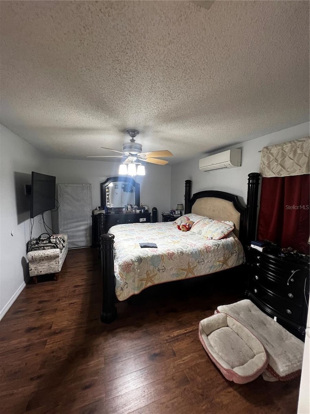 bedroom featuring a wall mounted air conditioner, ceiling fan, dark hardwood / wood-style floors, and a textured ceiling