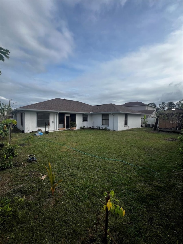 rear view of house with a yard