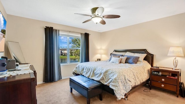 bedroom featuring light colored carpet, ceiling fan, and baseboards