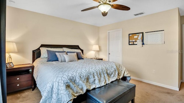 carpeted bedroom with a ceiling fan, visible vents, and baseboards