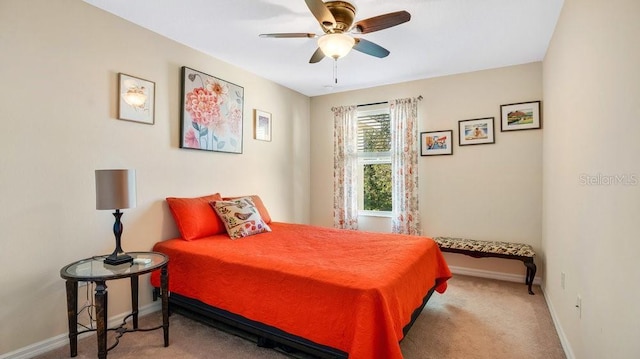 carpeted bedroom featuring baseboards and a ceiling fan