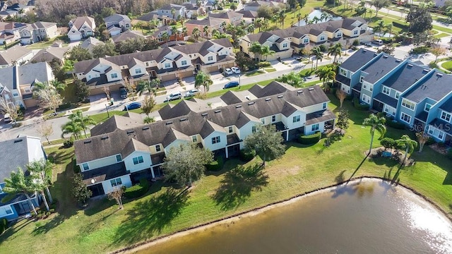 bird's eye view featuring a residential view and a water view