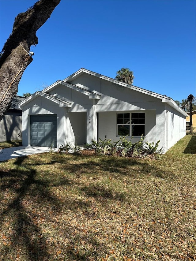 view of front of house with a garage and a front yard