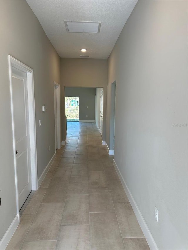 corridor featuring light tile patterned flooring