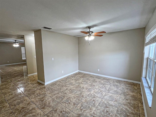 empty room featuring ceiling fan and a textured ceiling