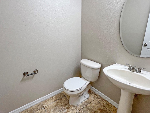 bathroom featuring tile patterned floors and toilet