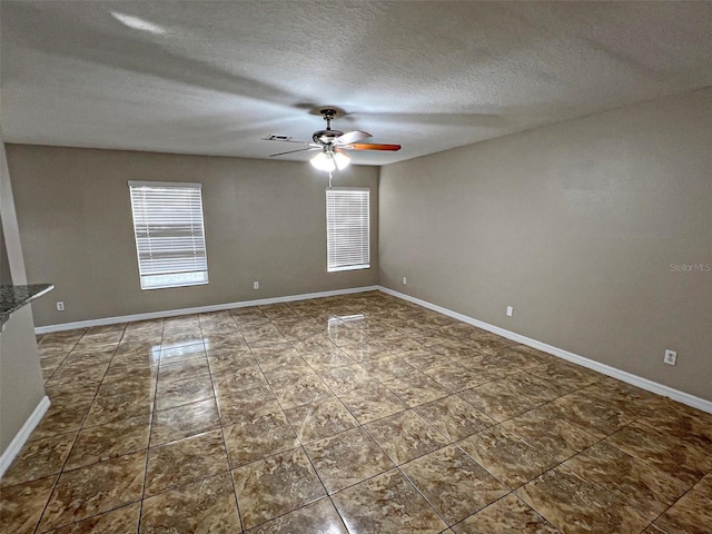 unfurnished room featuring a textured ceiling and ceiling fan