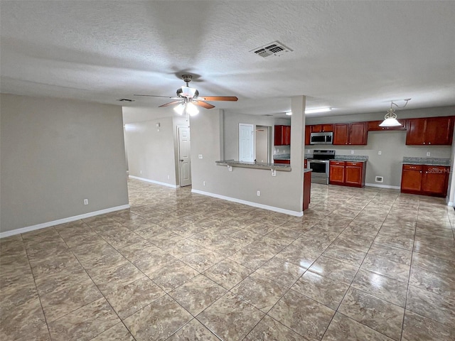 unfurnished living room with a textured ceiling and ceiling fan