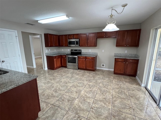 kitchen with light stone counters, a textured ceiling, stainless steel appliances, pendant lighting, and light tile patterned flooring