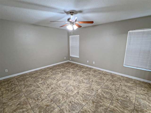 spare room featuring a textured ceiling and ceiling fan