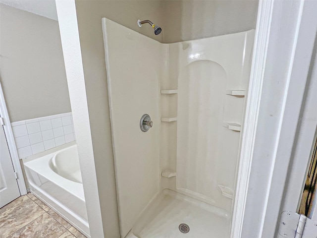 bathroom with shower with separate bathtub