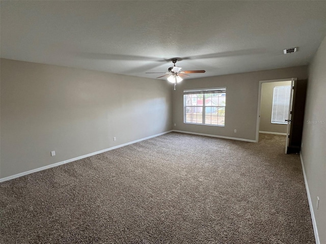 empty room featuring carpet flooring and ceiling fan