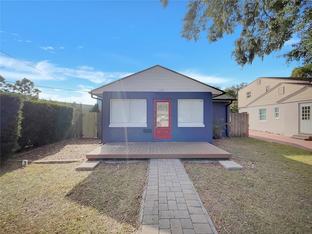 view of front facade with a front lawn and a deck