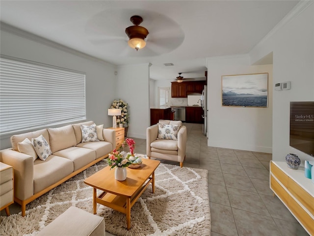 living room with light tile patterned floors, ceiling fan, and ornamental molding