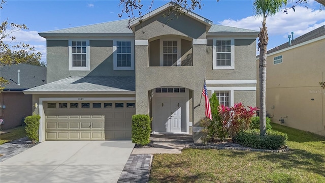 front facade featuring a front yard and a garage