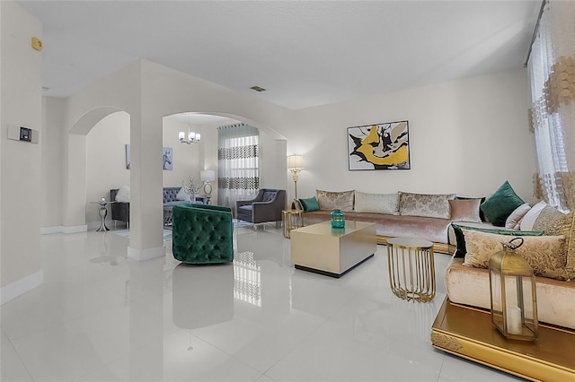 tiled living room featuring a notable chandelier