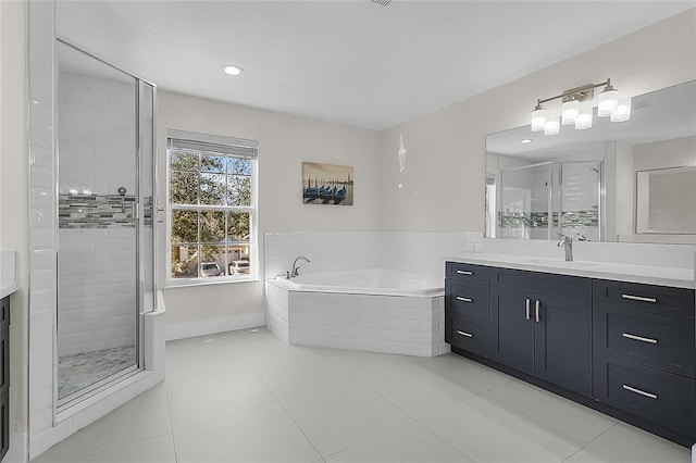 bathroom with tile patterned flooring, vanity, and plus walk in shower