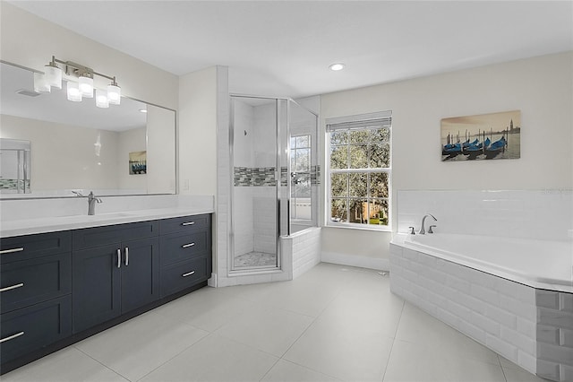 bathroom featuring tile patterned flooring, vanity, and plus walk in shower