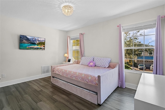 bedroom featuring dark hardwood / wood-style flooring