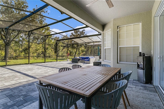 view of patio / terrace featuring outdoor lounge area, ceiling fan, and a lanai