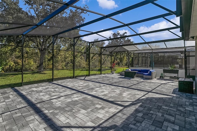 view of patio with outdoor lounge area and glass enclosure