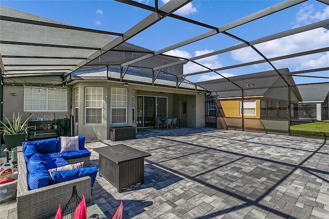 view of patio featuring glass enclosure and an outdoor hangout area