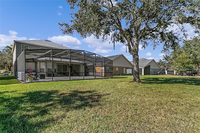 rear view of house with glass enclosure and a yard