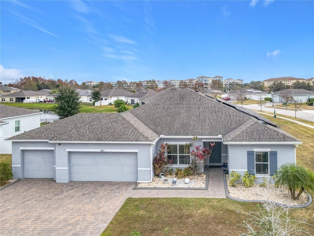 ranch-style home with a garage and a front lawn