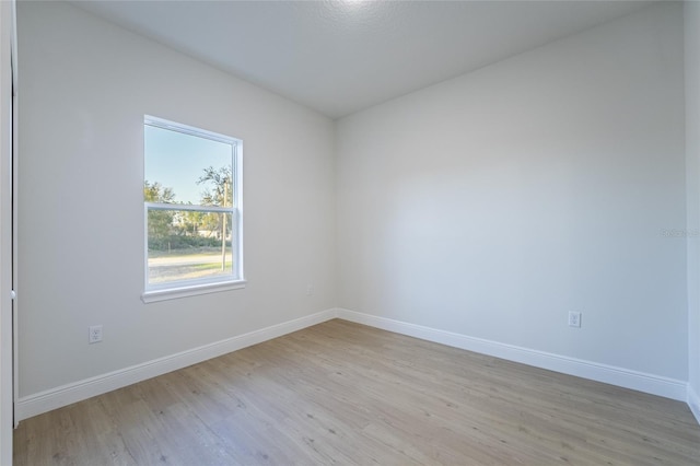 unfurnished room featuring light wood-style flooring and baseboards