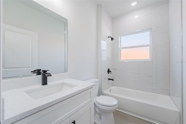 full bath with tub / shower combination, vanity, toilet, and wood finished floors