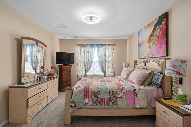 bedroom with multiple windows and light colored carpet